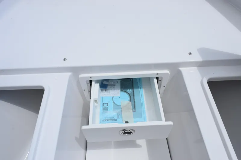 Slide: The Image of 2026 Sea Hunt Gamefish 27 Forward Seating storage compartment with open drawer. - 19