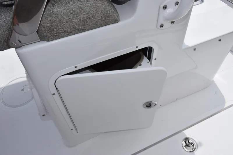 Slide: The Image of 2026 Sea Hunt Gamefish 27 storage compartment with open door, showcasing interior space. - 21