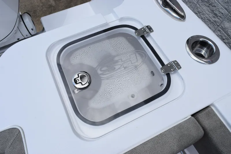 Slide: The Image of Livewell on 2026 Sea Hunt Gamefish 27 Forward Seating boat, featuring secure latch and cup holder. - 22