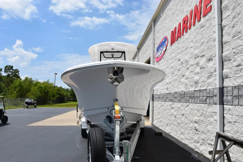 Slide: The Image of 2026 Sea Hunt Gamefish 27 boat on trailer outside marine dealership. - 3
