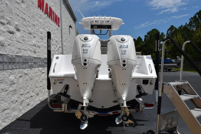 Slide: The Image of 2026 Sea Hunt Gamefish 27 with twin Yamaha 250 engines, parked outside a marine store. - 5