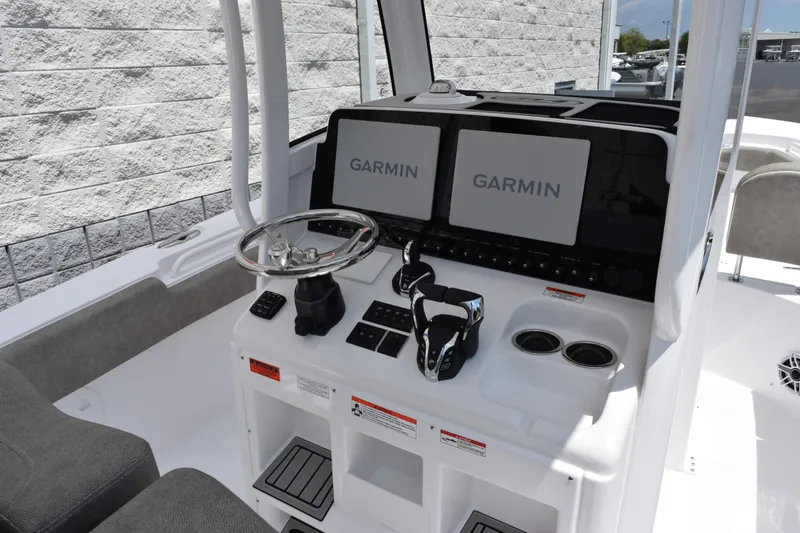 Slide: The Image of 2026 Sea Hunt Gamefish 27 helm with dual Garmin displays and modern controls. - 9