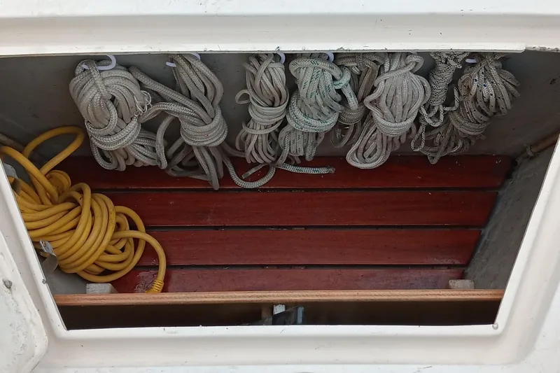 Slide: The Image of Coiled ropes in a storage compartment of a 1991 Gozzard 31 sailboat. - 11