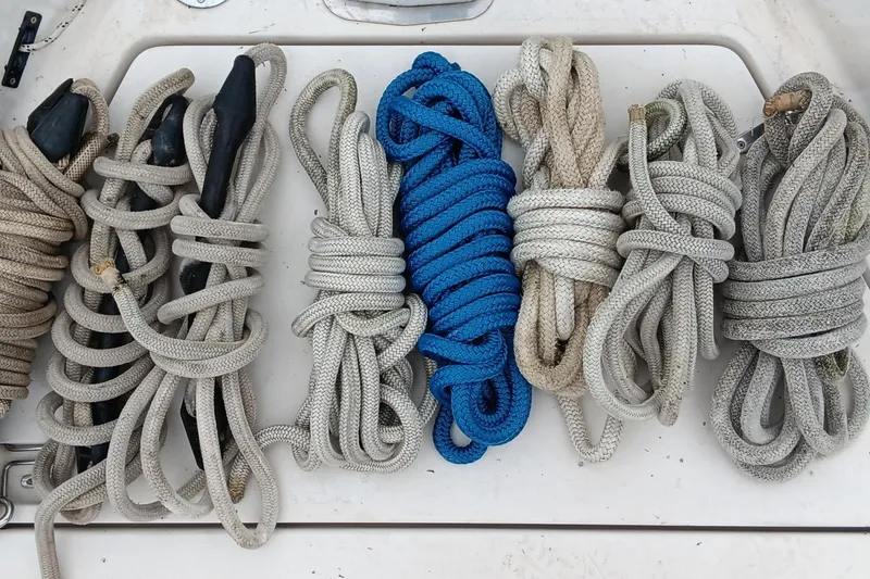 Slide: The Image of Coiled ropes on a 1991 Gozzard 31 boat deck, featuring a vibrant blue line. - 12
