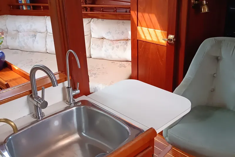 Slide: The Image of Interior of 1991 Gozzard 31 yacht with sink, seating, and wooden accents. - 17