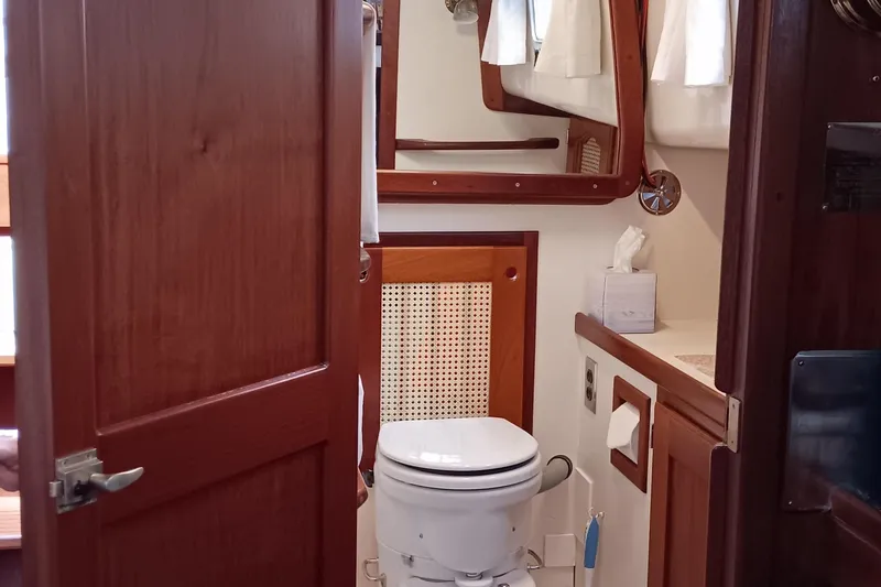 Slide: The Image of 1991 Gozzard 31 yacht bathroom with wooden accents and nautical decor. - 18
