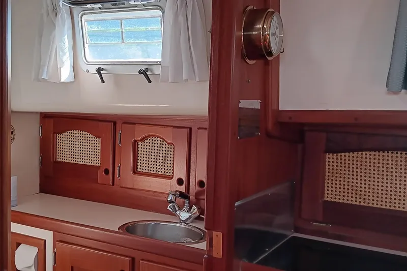 Slide: The Image of Interior of 1991 Gozzard 31 sailboat with wooden cabinetry and porthole window. - 19