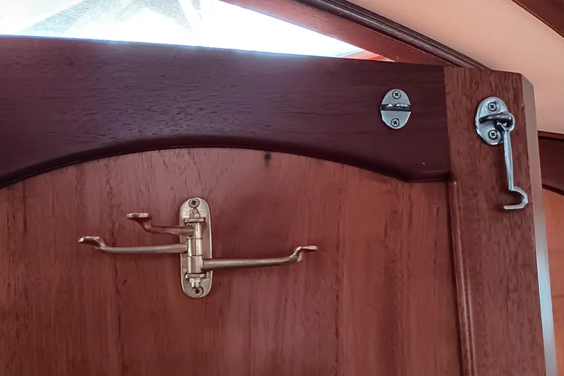 Slide: The Image of Wooden door with brass latch and hook on a 1991 Gozzard 31 boat. - 29