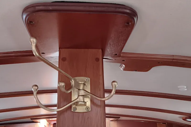 Slide: The Image of Brass coat hook on wooden interior of 1991 Gozzard 31 boat. - 32