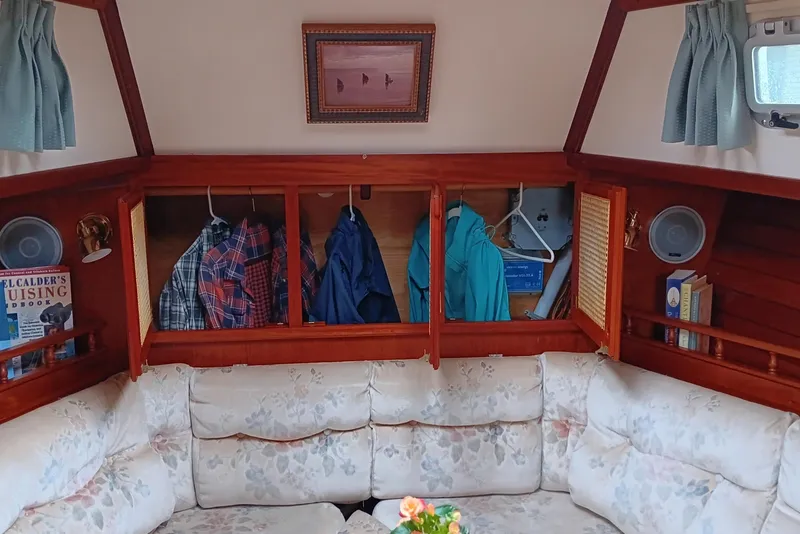 Slide: The Image of Interior of 1991 Gozzard 31 sailboat with cozy seating and storage cabinets. - 34