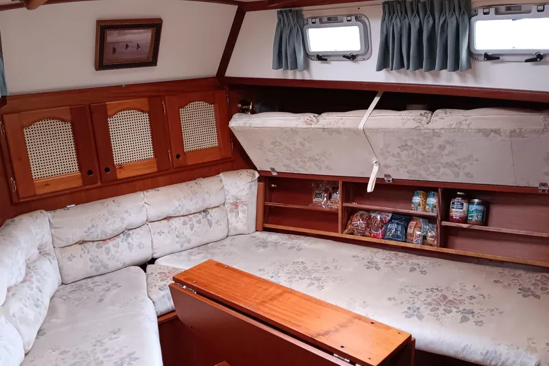 Slide: The Image of Interior of 1991 Gozzard 31 sailboat with cozy seating and storage compartments. - 37