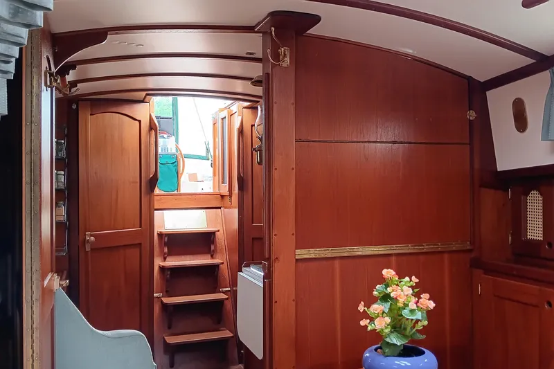 Slide: The Image of Interior of 1991 Gozzard 31 sailboat with wooden finish and floral decor. - 38