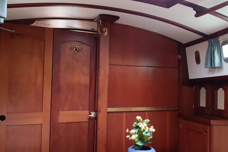 Slide: The Image of Interior of 1991 Gozzard 31 sailboat with wooden paneling and floral decor. - 39