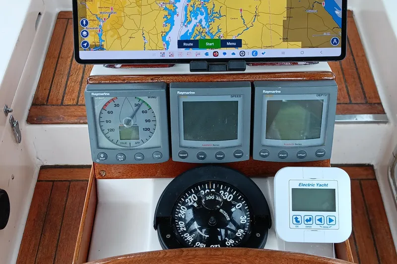 Slide: The Image of Navigation instruments on a 1991 Gozzard 31 yacht, featuring Raymarine displays and a compass. - 4