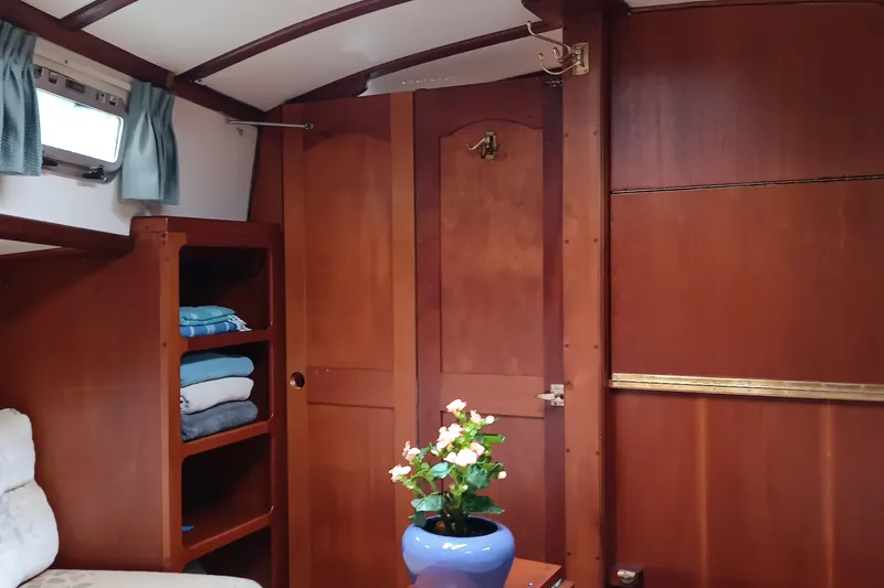Slide: The Image of Interior of 1991 Gozzard 31 sailboat with wooden cabinetry and floral decor. - 40