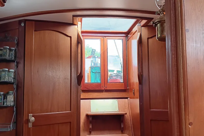 Slide: The Image of Interior of 1991 Gozzard 31 sailboat with wooden cabinetry and spice rack. - 44