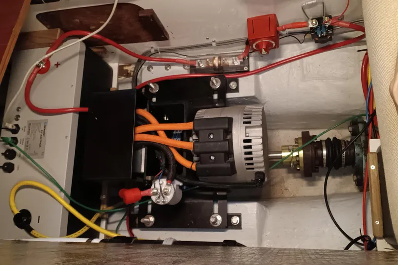 Slide: The Image of Engine compartment of a 1991 Gozzard 31 sailboat with visible wiring and components. - 56