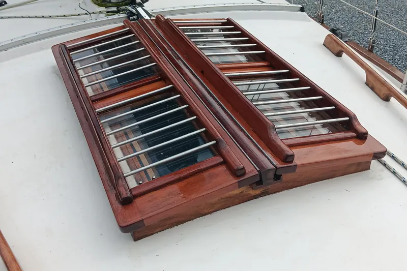 Slide: The Image of Wooden hatch with metal bars on a 1991 Gozzard 31 sailboat deck. - 6