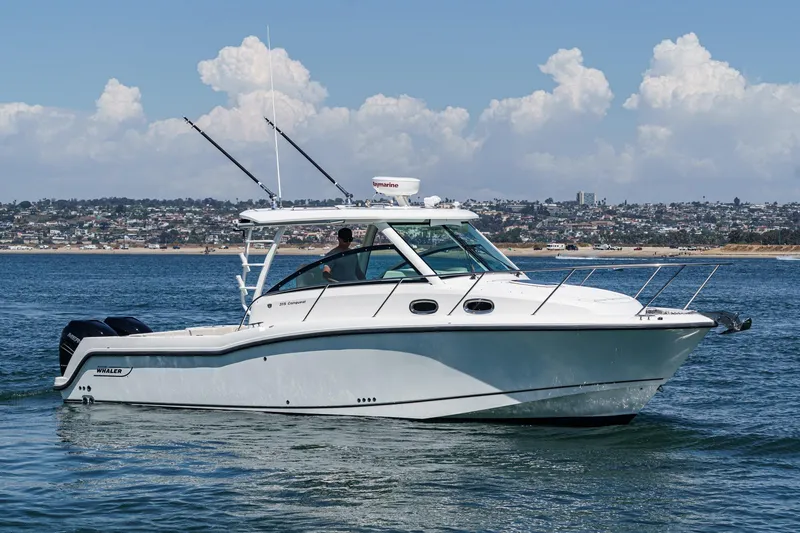Slide: The Image of 2018 Boston Whaler 315 Conquest cruising on calm waters under a clear sky. - 1