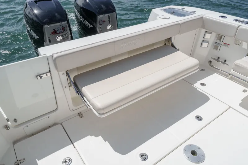 Slide: The Image of 2018 Boston Whaler 315 Conquest boat with foldable seating and dual Mercury outboard engines. - 11