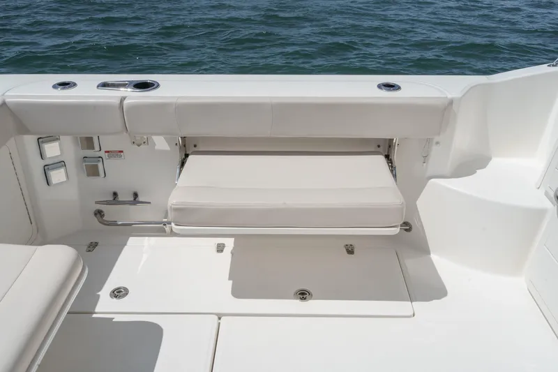 Slide: The Image of 2018 Boston Whaler 315 Conquest boat with foldable seating and ocean view. - 13