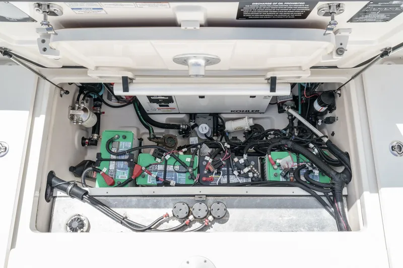 Slide: The Image of 2018 Boston Whaler 315 Conquest engine compartment with batteries and wiring. - 17