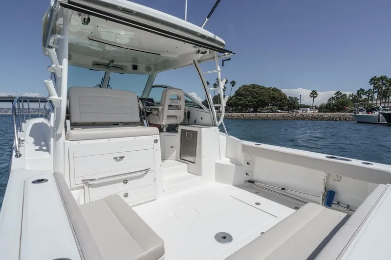Slide: The Image of 2018 Boston Whaler 315 Conquest boat interior, featuring spacious seating and modern amenities. - 18