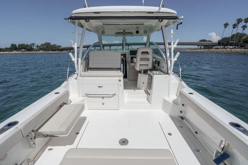 Slide: The Image of 2018 Boston Whaler 315 Conquest boat interior, featuring spacious seating and storage on open water. - 19