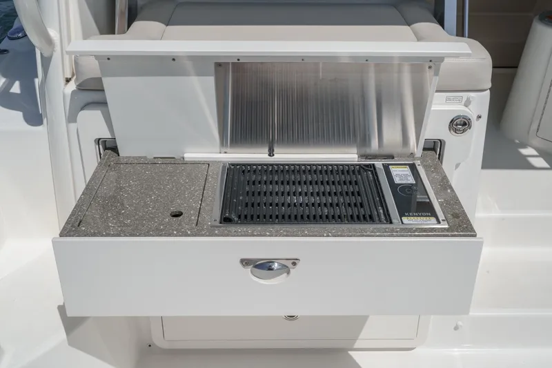 Slide: The Image of Outdoor grill on 2018 Boston Whaler 315 Conquest boat, featuring a sleek countertop design. - 23