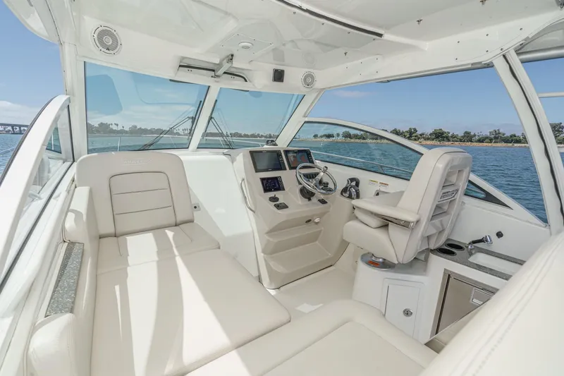Slide: The Image of 2018 Boston Whaler 315 Conquest interior with helm, seating, and ocean view. - 28