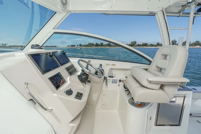 Slide: The Image of 2018 Boston Whaler 315 Conquest helm with modern controls and ocean view. - 29