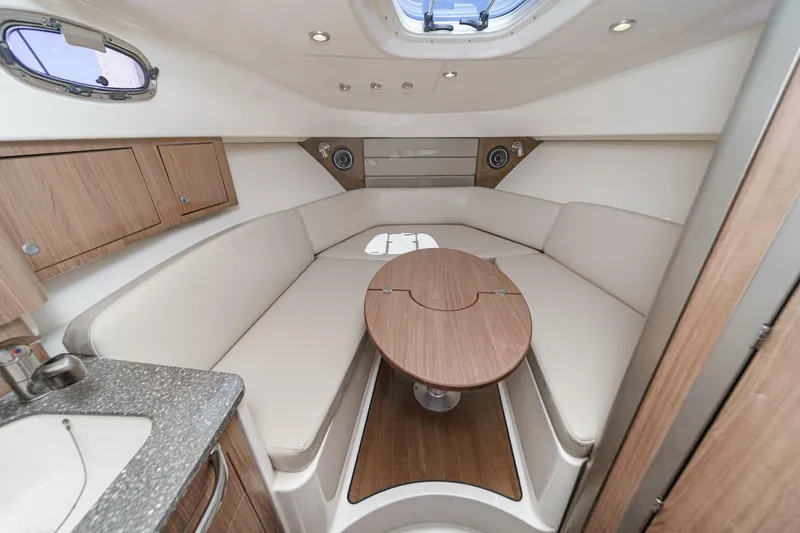 Slide: The Image of Luxurious interior of 2018 Boston Whaler 315 Conquest with elegant seating and wooden table. - 33