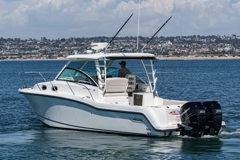 Slide: The Image of 2018 Boston Whaler 315 Conquest boat on water, featuring twin Mercury engines. - 4
