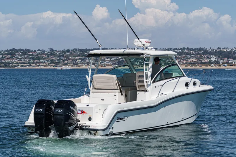 Slide: The Image of 2018 Boston Whaler 315 Conquest boat cruising on a sunny day near the coastline. - 6