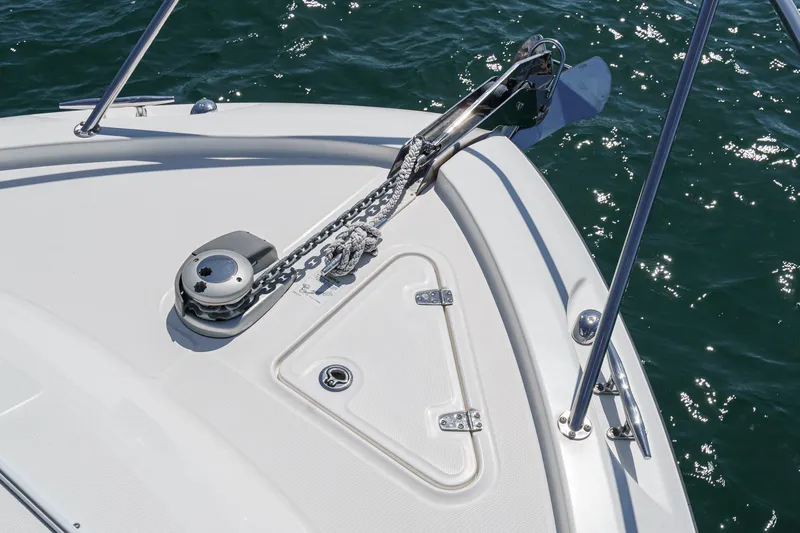 Slide: The Image of 2018 Boston Whaler 315 Conquest boat anchor system on deck, with ocean background. - 8