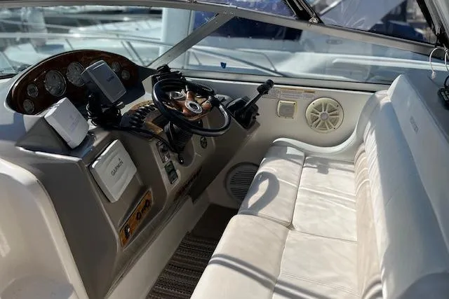 Slide: The Image of 2006 Rinker Fiesta Vee 342 boat interior with steering wheel and seating area. - 10