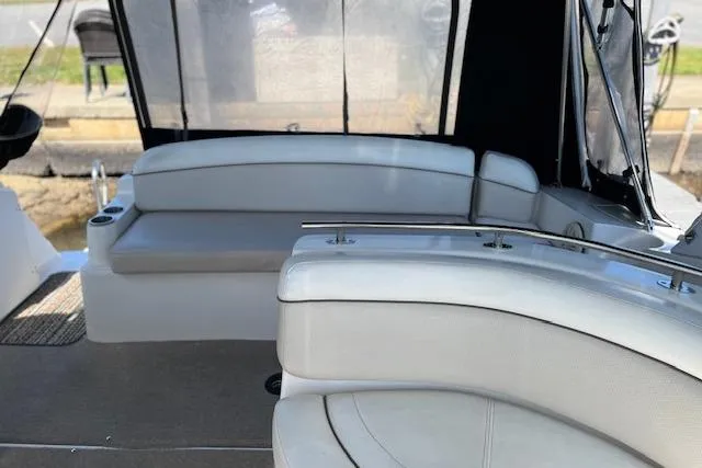 Slide: The Image of 2006 Rinker Fiesta Vee 342 boat interior with white seating and sleek design. - 11
