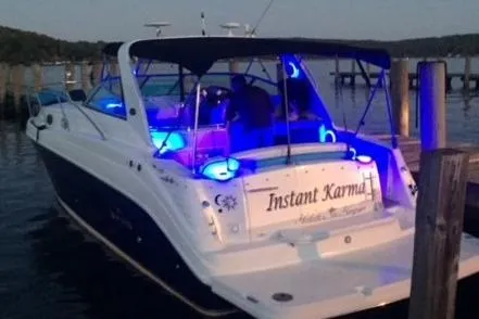 Slide: The Image of 2006 Rinker Fiesta Vee 342 boat docked with blue interior lights at dusk. - 13