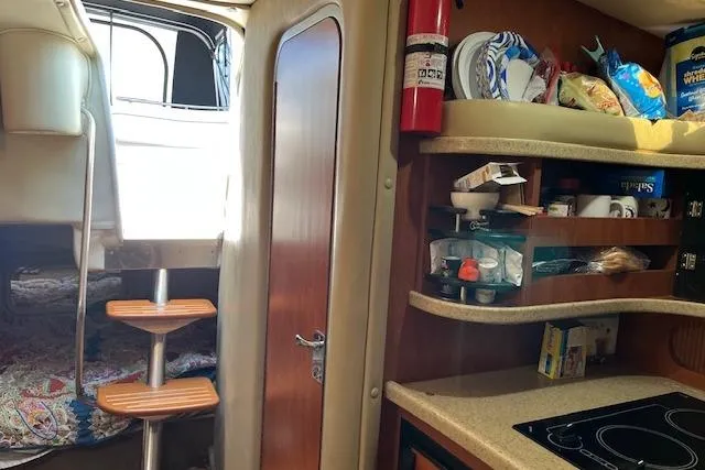 Slide: The Image of Interior of 2006 Rinker Fiesta Vee 342 boat with kitchenette and sleeping area. - 5