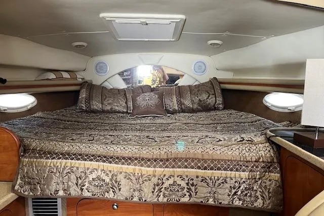 Slide: The Image of Luxurious cabin interior of 2006 Rinker Fiesta Vee 342 with elegant bedding. - 8