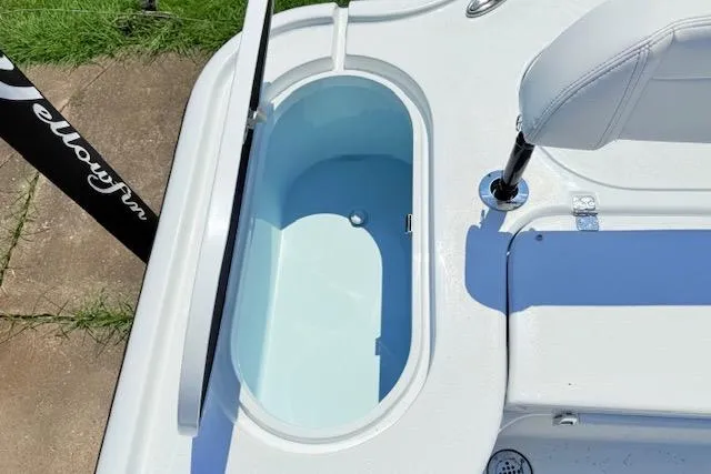 Slide: The Image of 2026 Yellowfin 24 Bay CE boat interior with open storage compartment. - 15