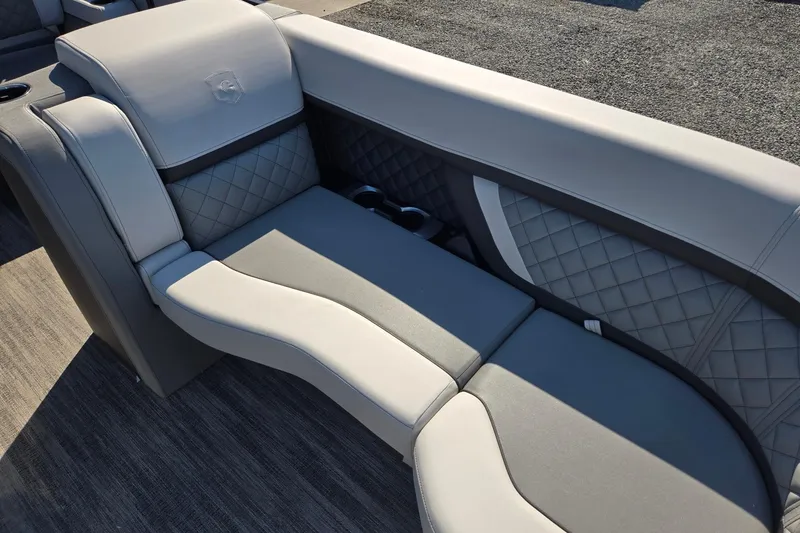 Slide: The Image of Luxurious seating on 2026 Godfrey AquaPatio 255 SFL boat, featuring quilted upholstery and modern design. - 11