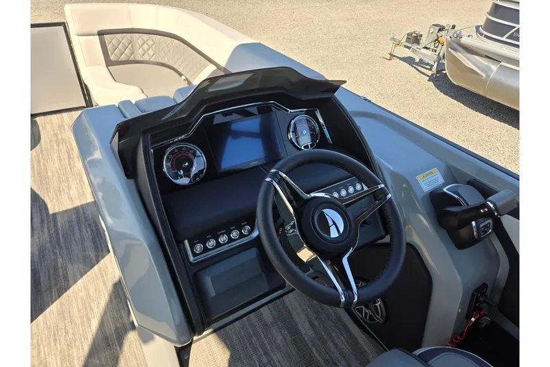 Slide: The Image of 2026 Godfrey AquaPatio 255 SFL boat dashboard with steering wheel and controls. - 15