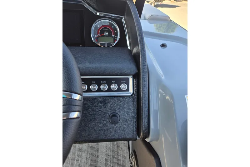 Slide: The Image of 2026 Godfrey AquaPatio 255 SFL dashboard with steering wheel and control panel. - 18