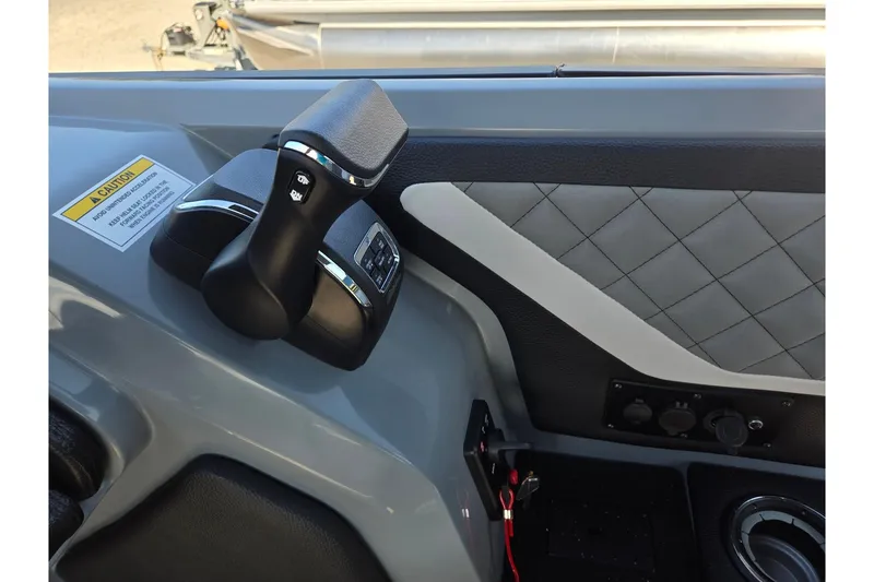 Slide: The Image of 2026 Godfrey AquaPatio 255 SFL boat control panel with throttle and switches. - 20