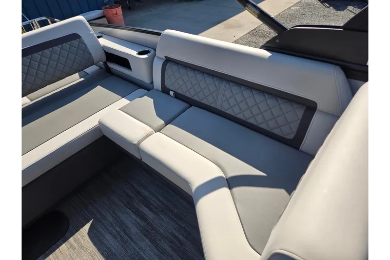Slide: The Image of 2026 Godfrey AquaPatio 255 SFL boat interior with luxurious seating and quilted upholstery. - 24