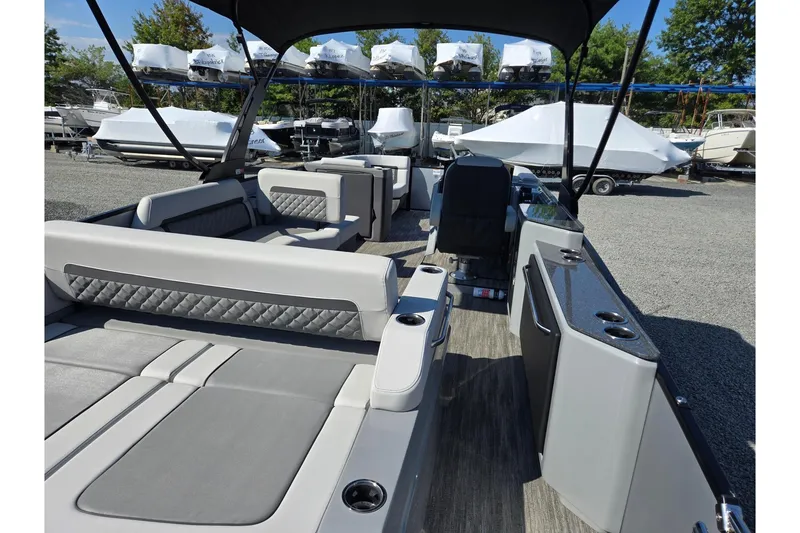 Slide: The Image of 2026 Godfrey AquaPatio 255 SFL pontoon boat interior with luxurious seating and modern design. - 28