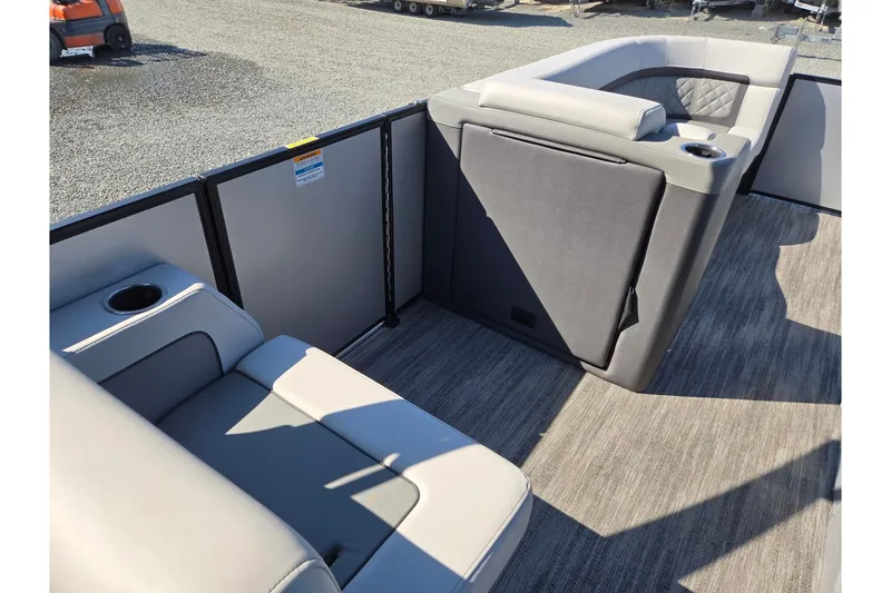 Slide: The Image of 2026 Godfrey AquaPatio 255 SFL boat interior with gray seating and cup holders. - 32