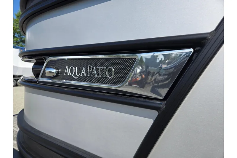 Slide: The Image of Close-up of 2026 Godfrey AquaPatio 255 SFL boat emblem with chrome detailing. - 37