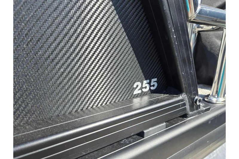 Slide: The Image of Close-up of 2026 Godfrey AquaPatio 255 SFL with carbon fiber texture and chrome details. - 40